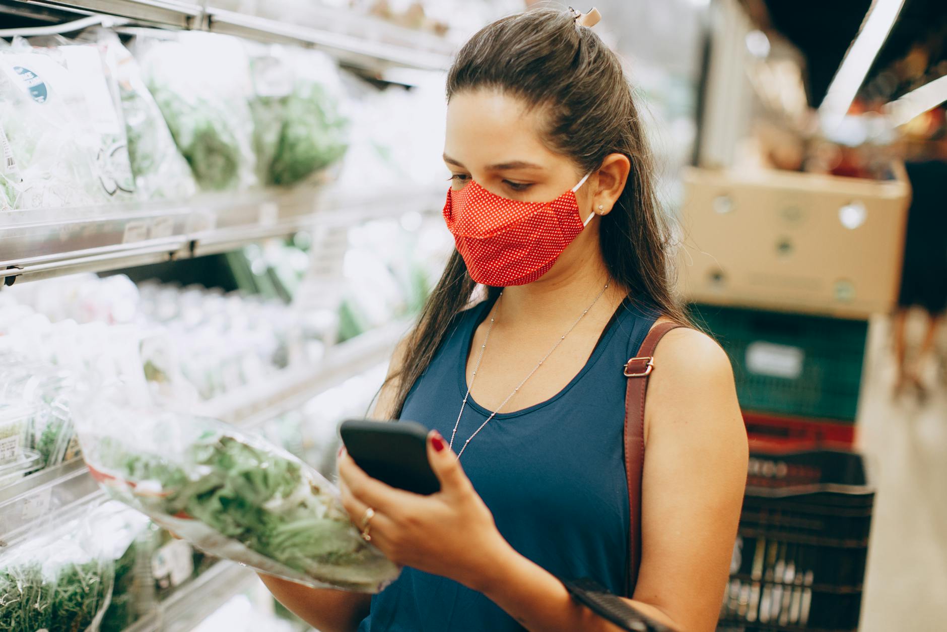 woman in face mask shopping in supermarket